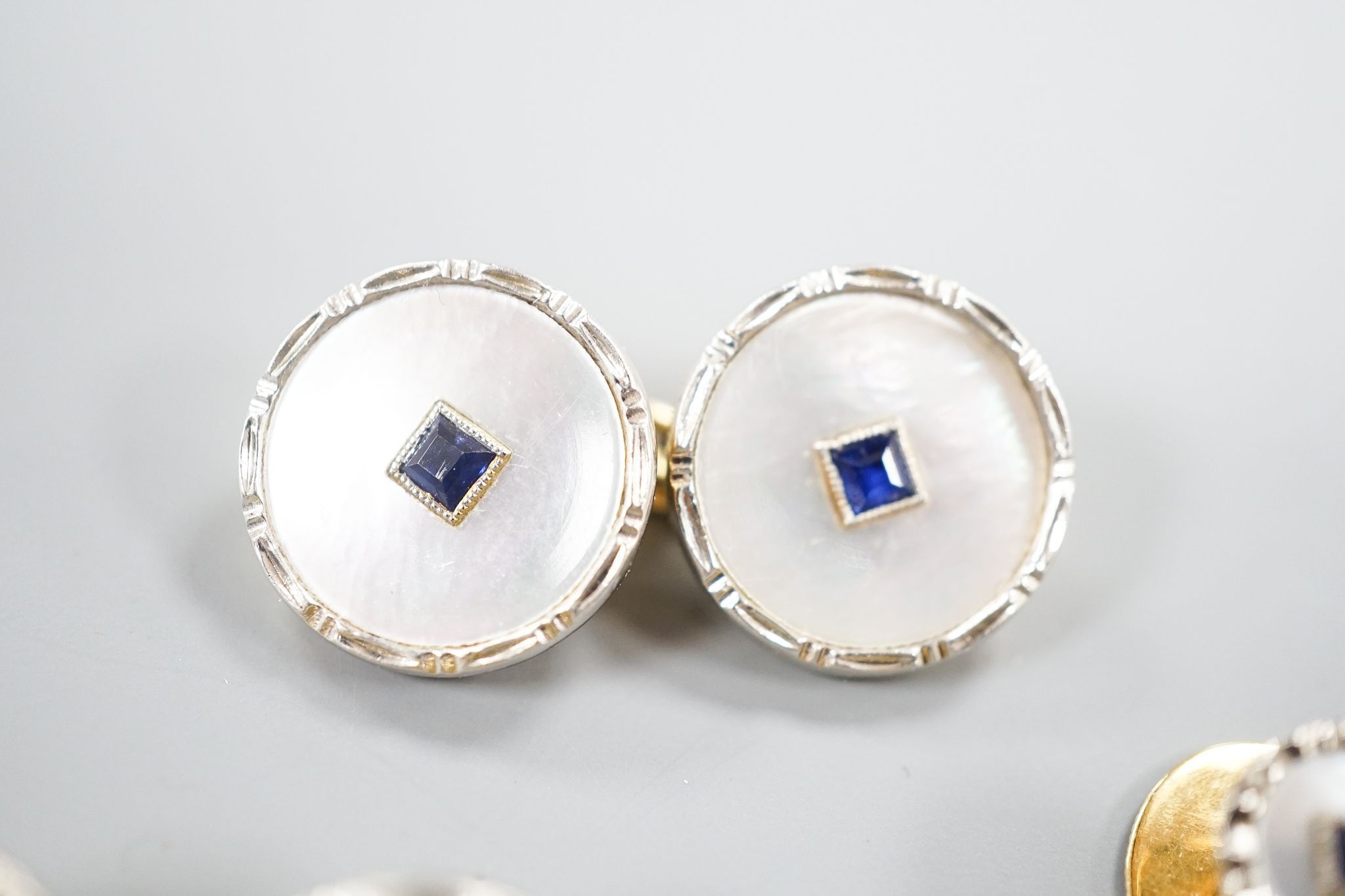 A pair of 18ct, mother of pearl and sapphire set circular cufflinks, 13mm and a pair of matching dress studs, gross weight 8.6 grams.
